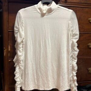 White long sleeve shirt with sheer sleeves.